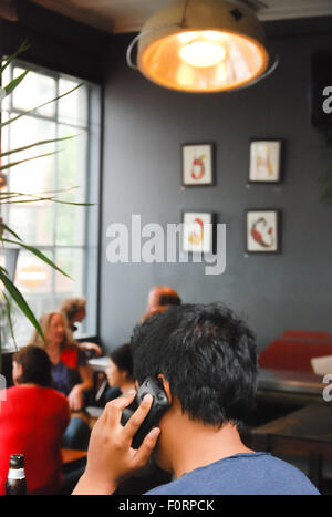 Man using cell phone at the cafe. Stock Photo