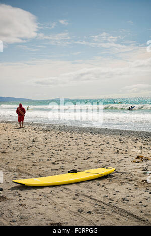 Yellow surfboard on a beach in Ireland Stock Photo