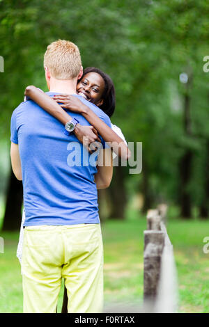 Couple in love hugging peacfully outdoors and being truly happy. Feeling of security and serenity Stock Photo