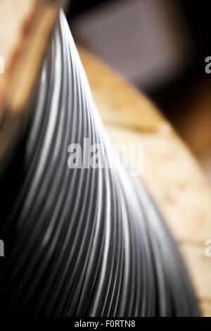 Black electrical cable on a wooden roll Stock Photo