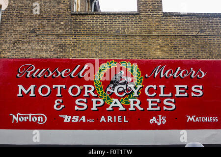 A sign for a shop that sells motorcycle parts and repairs including BSA Norton Matchless Ariel AJS Stock Photo