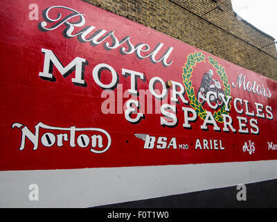 A sign for a shop that sells motorcycle parts and repairs including BSA Norton Matchless Ariel AJS Stock Photo