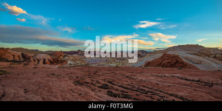 Fire Wave Panorama black pebbles, multicolored rock formations and blue sunset sky Stock Photo
