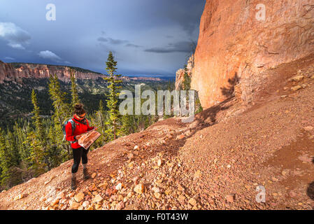 Woman Backpacker hiking down the Ponderosa Canyon Bryce National Park Stock Photo