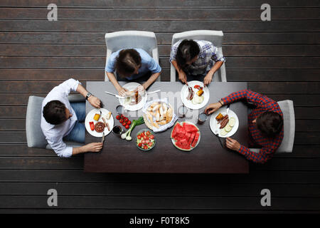 two couples eating dinner Stock Photo