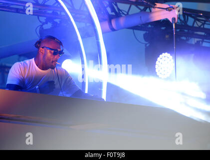 Idris Elba smokes a hand-rolled cigarette while playing a DJ set at the Goodwood Racecourse in West Sussex, at the last of their 'Three Friday Nights' events  Featuring: Idris Elba Where: Chichester, West Sussex, United Kingdom When: 19 Jun 2015 Stock Photo