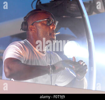 Idris Elba smokes a hand-rolled cigarette while playing a DJ set at the Goodwood Racecourse in West Sussex, at the last of their 'Three Friday Nights' events  Featuring: Idris Elba Where: Chichester, West Sussex, United Kingdom When: 19 Jun 2015 Stock Photo