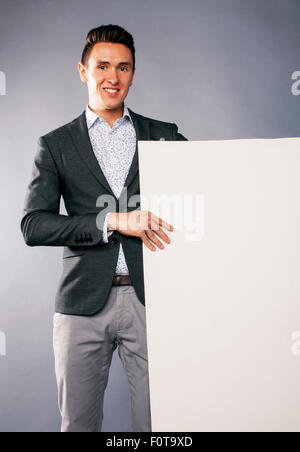 young handsom businessman in suit with poster empty copy space Stock Photo