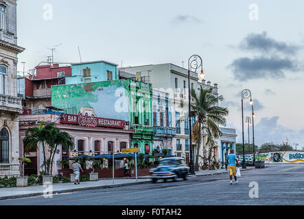 Brightly coloured pastel shaded buildings on the seafront at Malecon in Havana Cuba with splendid early morning light Stock Photo