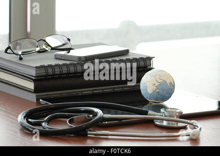 stethoscope and texture globe with digital tablet as medical network concept Stock Photo