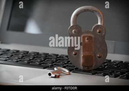 Internet security concept-old padlock and key on laptop computer keyboard Stock Photo