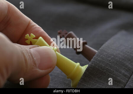 Close up of hands of a business man moving king golden chess to defeat  opponent the chess game is development analysis, strategy, and plan, the  management or leadership concept. 22804709 Stock Photo