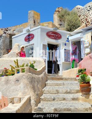 A female tourist outside a souvenir shop in Oia Santorini Greece Stock Photo