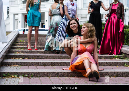 A big group of girls (females) posing in a front of a camera before prom ceremony Stock Photo