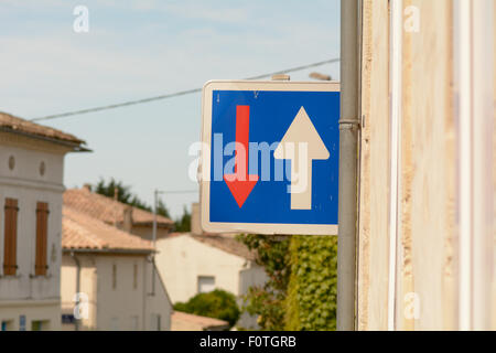 Give way to oncoming traffic road sign in small French village Stock Photo