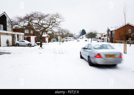 Car driving in winter snow on a road in England Stock Photo