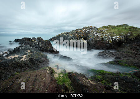 As the sun goes down, the clouds roll in and the tide comes in at Helen's Bay, County Down, Northern Ireland Stock Photo