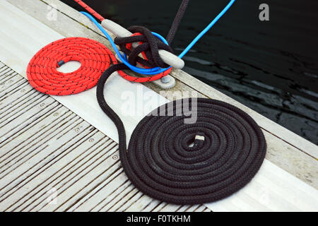 Coiled ropes on the quayside Stock Photo