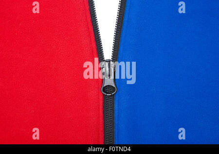 Plain opening black zipper on a red and blue jacket against a white background Stock Photo