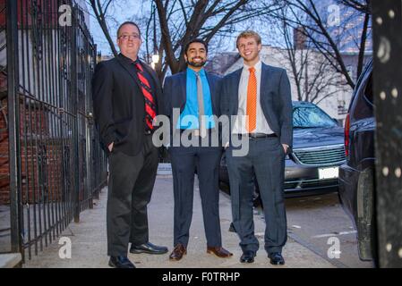 Portrait of three young male friends wearing suits for night out Stock Photo