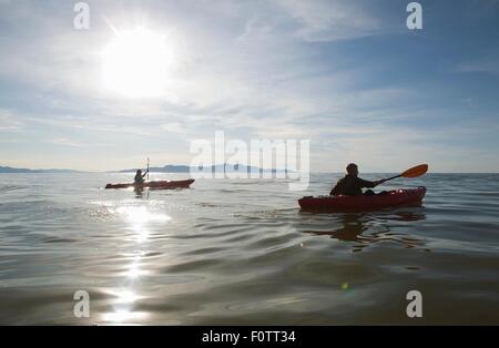 Couple kayaking, sunlight reflecting on water, Great Salt Lake, Utah, USA Stock Photo