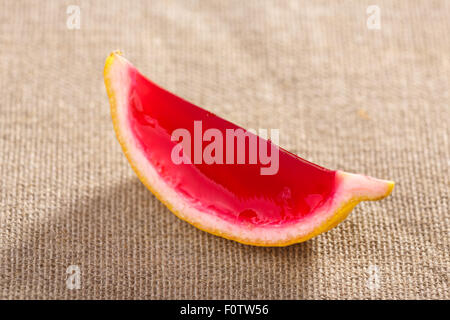 Lemon tequila strawberry jelly (jello) shot on a linen clothed table. Unusual adult party drink Stock Photo