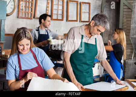 Workers Manufacturing Papers In Factory Stock Photo