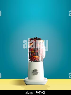 Fresh berries and citrus fruit in juicer Stock Photo