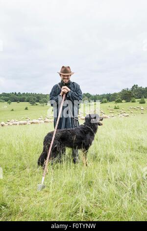Portrait of farmer and sheepdog Stock Photo