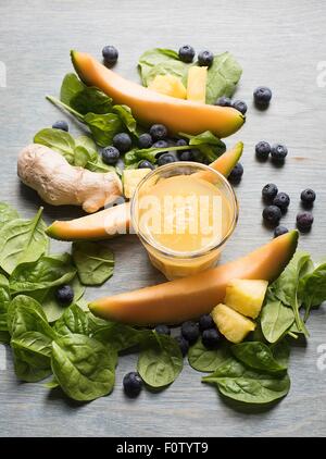 Slices of fresh melon with spinach and a fruit and vegetable smoothie Stock Photo