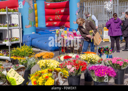 Colourful and busy with shoppers at the outdoor weekly market stalls in the small Staffordshire town of Penkridge Stock Photo