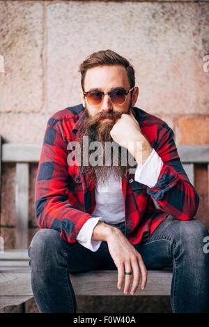 Portrait of man with beard wearing sunglasses Stock Photo