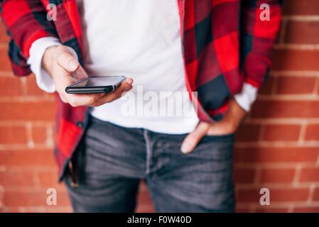 Detail shot of man's hands holding smartphone Stock Photo