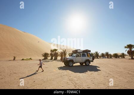 Boy walking on sand, Dune 7, Namib-Naukluft National Park, Africa Stock Photo