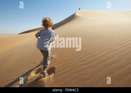 Boy walking on sand, Dune 7, Namib-Naukluft National Park, Africa Stock Photo