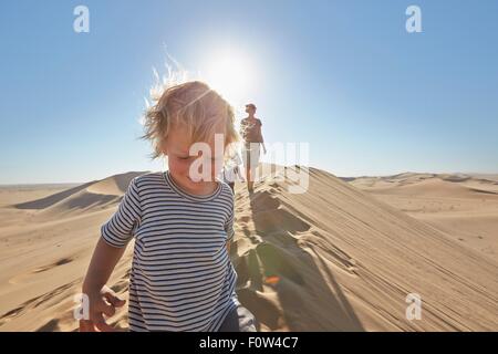 Mother and sons walking on sand dune, Dune 7, Namib-Naukluft National Park, Africa Stock Photo