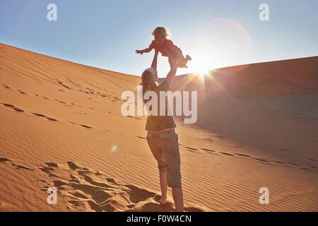 Mother playing with son on sand dune, Namib Naukluft National Park, Namib Desert, Sossusvlei, Dead Vlei, Africa Stock Photo