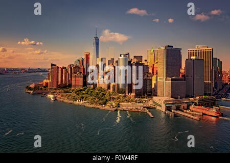 Lower Manhattan Aerial View - Aerial view to lower Manhattan, Battery Park and the Financial District in New York City. Seen is One World Trade Center (WTC) commonly referred to as the Freedom Tower, the Staten Island Ferry Terminal along with other skyscrapers and landmarks that make up the New York City (NYC) skyline. Stock Photo