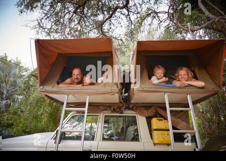 Family in sleeping tents on top of off road vehicle, Ruacana, Owamboland, Namibia Stock Photo