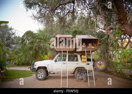 Family in sleeping tents on top of off road vehicle, Ruacana, Owamboland, Namibia Stock Photo