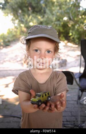 Portrait of young boy holding toy car Stock Photo