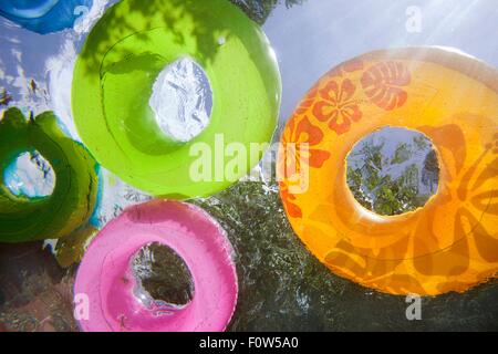 Underwater shot of inflatable rings in swimming pool Stock Photo
