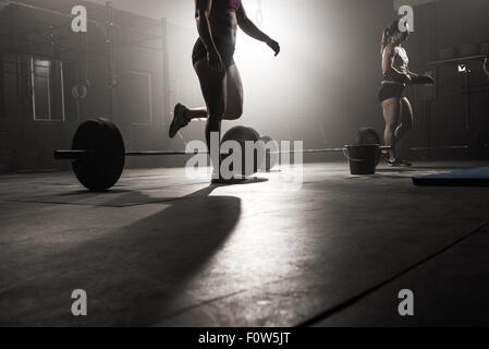 Two young women working out in gym Stock Photo