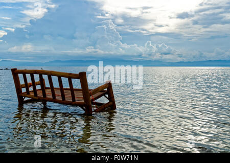 A Bamboo Chair is Soaked in the Ocean. It is a local practice to use bamboo chairs and tables and soaked them once a year for fe Stock Photo