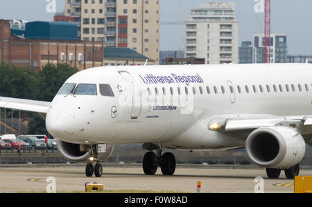 A Lufthansa CityLine Embraer ERJ-190 registration D-AECC taxis for take off at London City Airport LCY. Stock Photo
