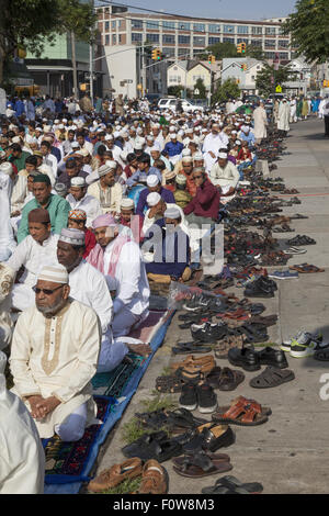 Muslims pray outside a mosque in Kensington, Brooklyn, NY for 'Eid al-Fitr.' The holiday,celebrated around the world, marks the Stock Photo