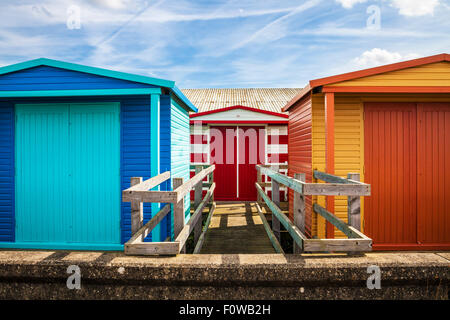 Colourful wooden beach huts in the Kentish coastal resort of Whitstable. Stock Photo