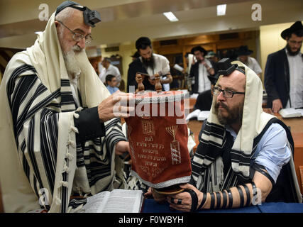 After a Torah reading the scroll covered and about to be returned to the Holy Ark at Jewish services in a synagogue in New York. Stock Photo