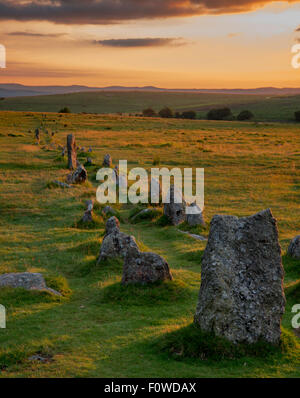 Sun setting behind the stone rows at Merrivale on Dartmoor. Stock Photo