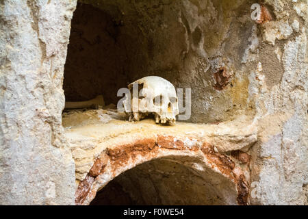 Human Skull in the chamber in a crypt of the Punic Wall at Cartagena, Murcia, Spain Stock Photo